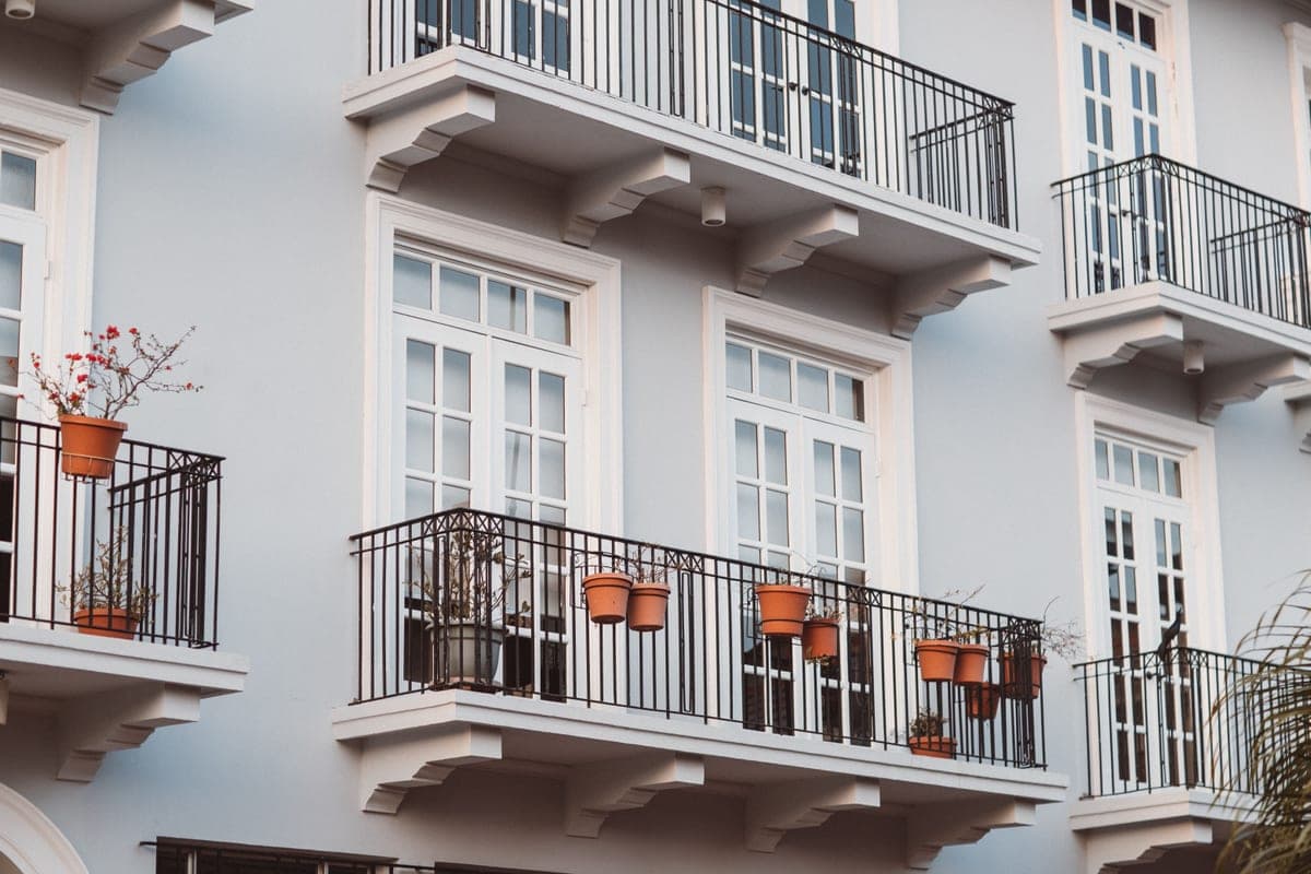 A modern apartment building with planted balconies
